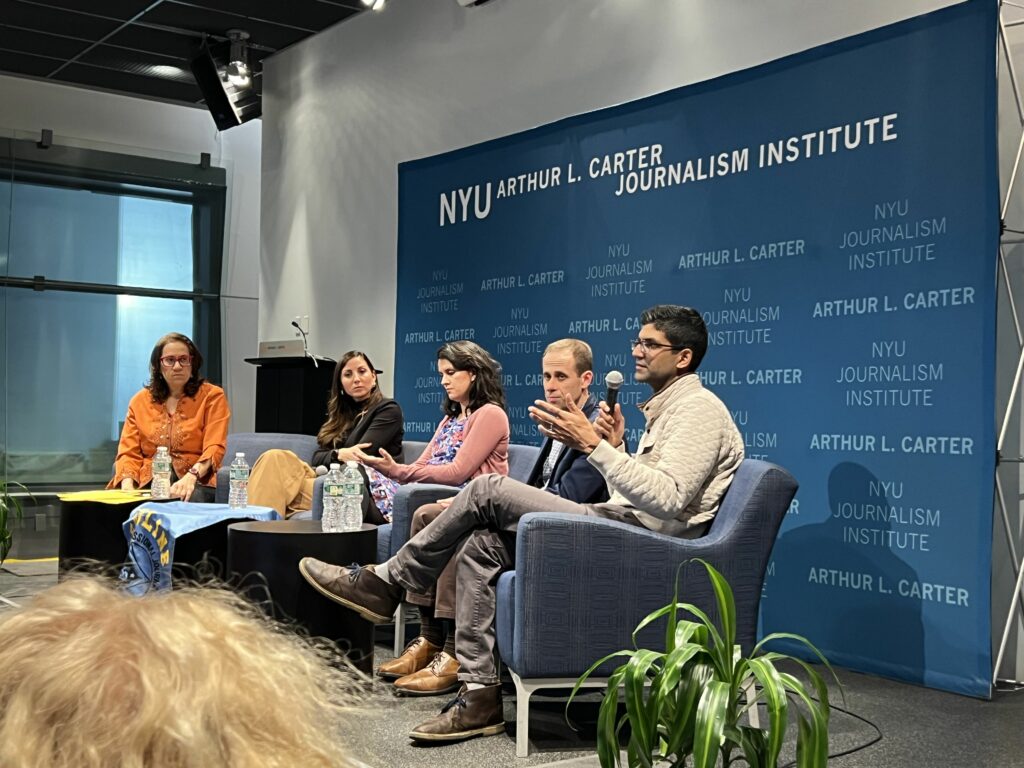 Photo of the speakers in conversation.