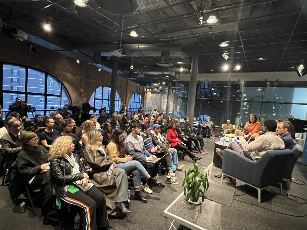 Photo of a crowded room of attendees.